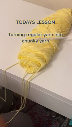 a yellow yarn ball sitting on top of a white table