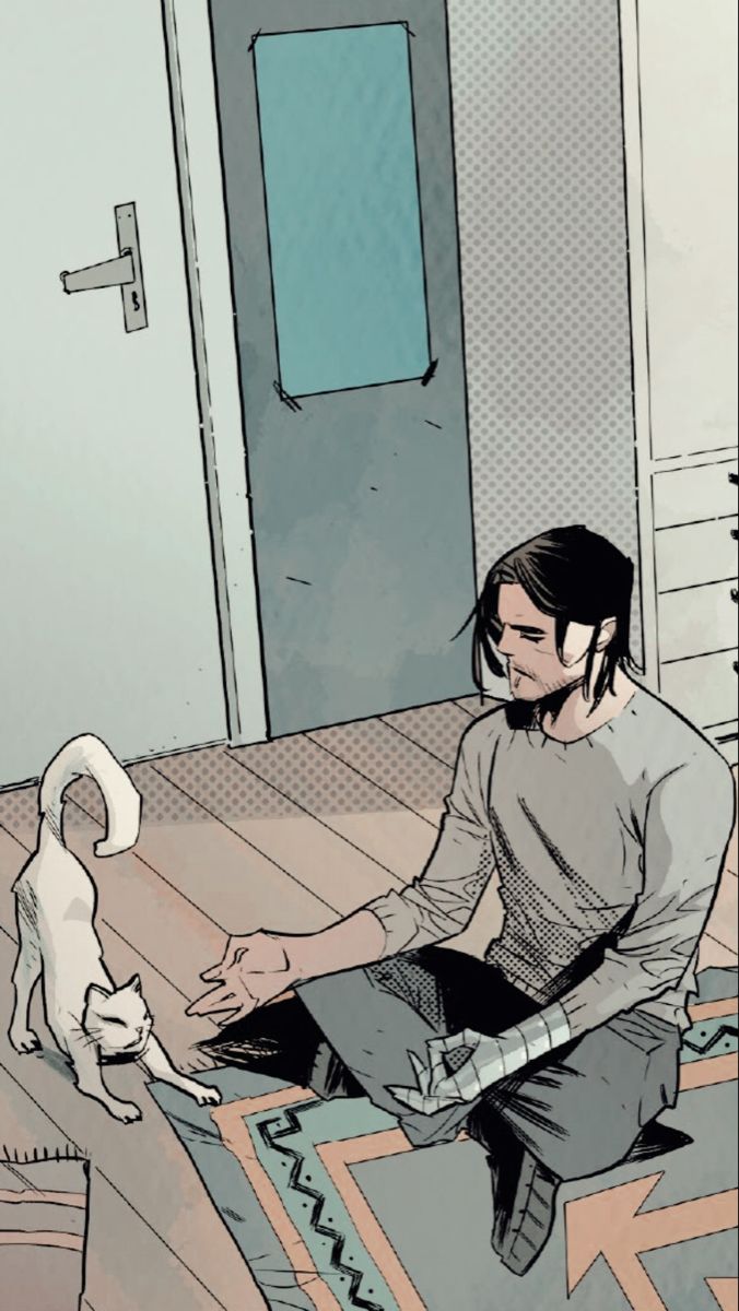 a man sitting on the floor petting a dog