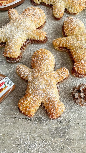 some cookies are laying on a table next to nuts