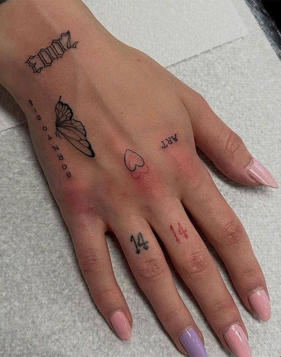 a woman's hand with tattoos on it