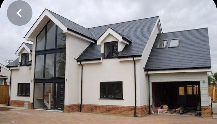 a white house with black roof and windows