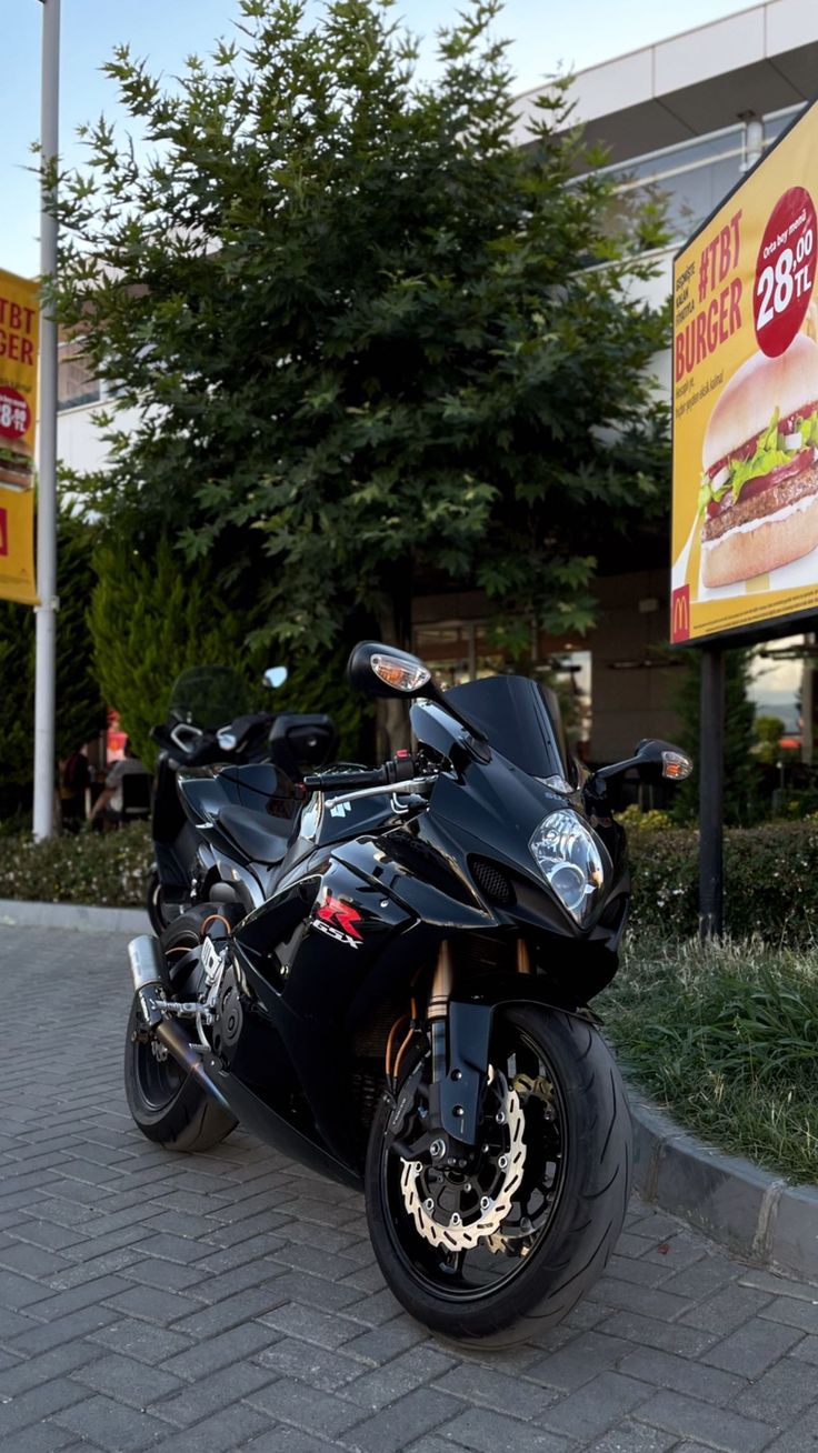 a black motorcycle parked in front of a fast food restaurant