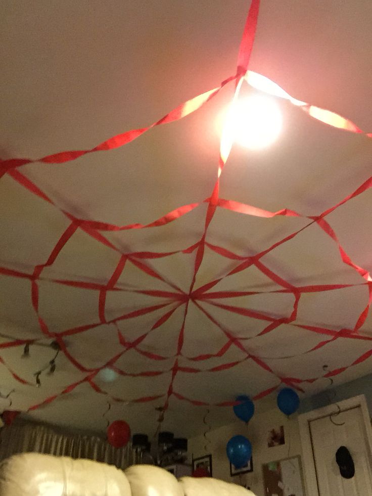 the ceiling is decorated with red and white streamers, balloons, and other decorations