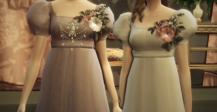 two women standing next to each other wearing dresses with flowers on the front and back