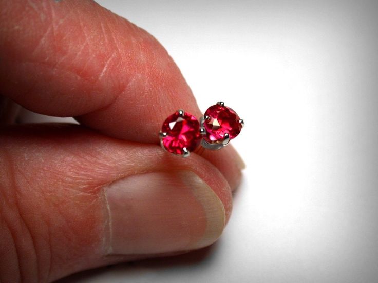 Classic birthstone earrings, simulated red ruby earrings. Set in solid 14K yellow or white gold. The imitation rubies are a beautiful, bright red, with even just a bit more sparkle and better clarity than genuine rubies themselves. Ideal as the July birthstone. Measuring 4.0mm in diameter. Also available in 5.0mm, 6.0mm, 7.0mm. The 14K gold mountings and backs are of solid cast mounts, die struck, and will give a lifetime of enjoyment. Ships in 1 to 2 business days. Gift boxed. Classic Ruby Birthstone Earrings, Ruby Gemstone Earrings As Gift, Lab-created Ruby Gemstone Earrings As Gift, Lab-created Ruby Gemstone Earrings For Gift, Round Ruby Gemstone Earrings, Red Round Earrings With Prong Setting, Round Lab-created Ruby Gemstone Earrings, Formal Ruby Birthstone Earrings, Round Lab-created Ruby Earrings With Prong Setting