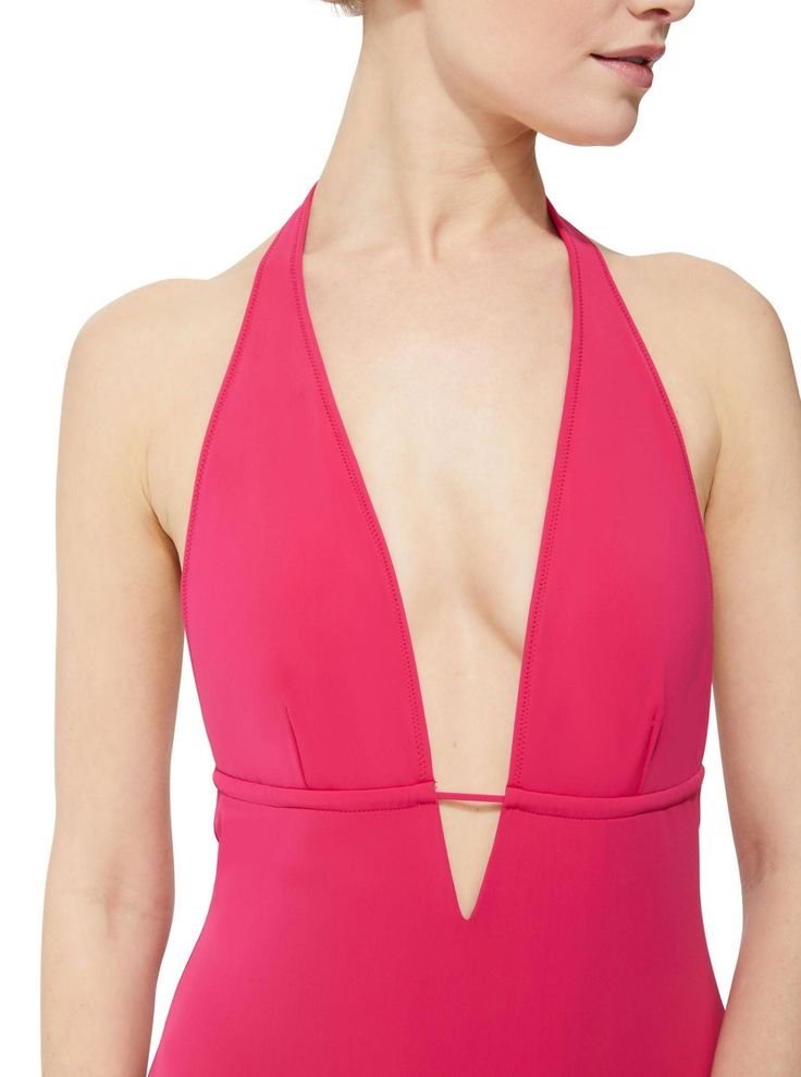 With a sexy plunging neckline, Elizabeth is sleek, modern and slimming. The clean-cut silhouette enhances your figure and compliments your curves in all of the right places. Designed for versatility, an adjustable halter-neck tie and under-bust string allow you to personalize your fit – you choose the spacing of the front cups, and a just right fit in the back. Color: Fuchsia Fabric: 78% Recycled Repreve® Nylon 22% Spandex Certified UPF 50+ to block 99% of UVA and UVB rays Fully lined Halter nec Elegant Stretch Swimwear With Boning, Elegant Triangle Top Swimwear For Spring, Fitted Low-cut Swimwear For Spring, Elegant Pink Lined Swimwear, Elegant Triangle Top Stretch Swimwear, Elegant V-neck Party Swimwear, Elegant Elastane Swimwear For Spring, Fitted Low-cut Swimwear For Night Out, Fitted Solid Color Swimwear With V-neck