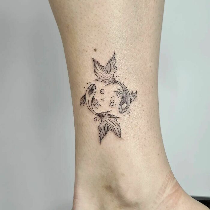 a woman's foot with a small fish tattoo on the side of her leg