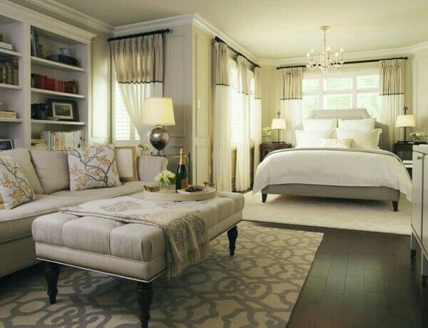 a living room filled with furniture and a large white bed in the middle of it