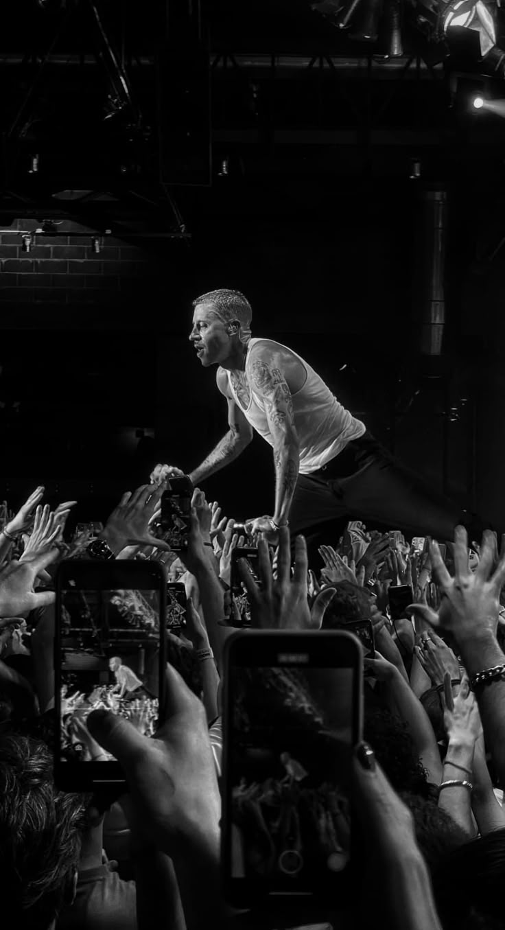 a man standing on top of a crowd of people