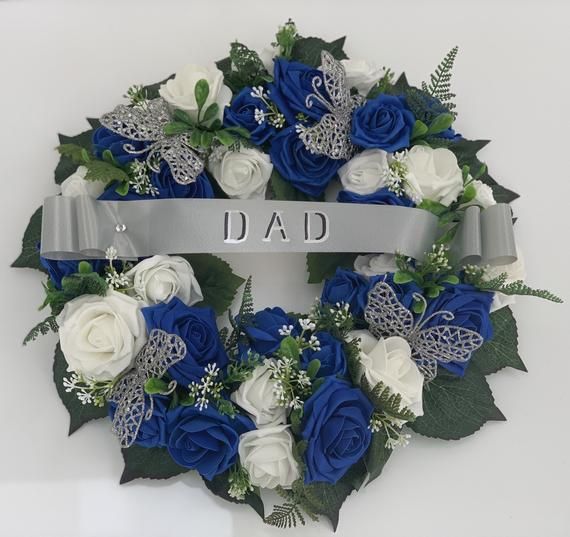 a blue and white wreath with the word dad on it