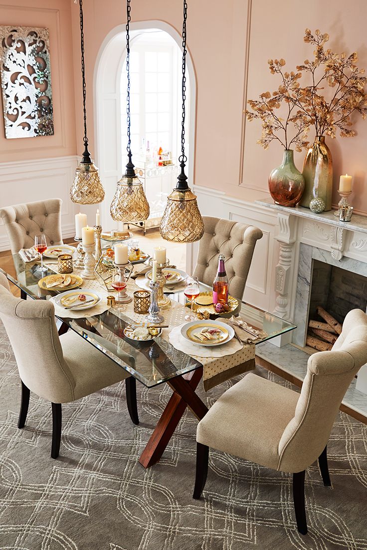 the dining room table is set up with chairs, plates and food on top of it