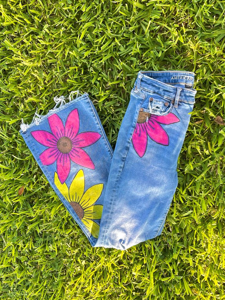 Bright and summery floral denim jeans are the perfect accent piece for your outfit of the day. Dress them up or dress them down they could go either way. This piece is customizable to your favorite pair of denim flares or bootcut jeans and features three large brightly colored flowers on the front with nothing on the back. Flowers can be added on the back for a small up-charge. For reference, I am a size  US 4 which is displayed in pictures. Floral Print Flare Bottoms For Spring, Summer Cotton Flare Jeans, Pink Denim Flare Jeans For Summer, Pink Denim Flare Jeans For Spring, Yellow Straight Leg Jeans For Summer, Yellow Wide Leg Jeans For Summer, Hippie Wide Leg Jeans For Spring, Wide Leg Hippie Jeans For Spring, Cotton Hippie Flare Jeans For Spring