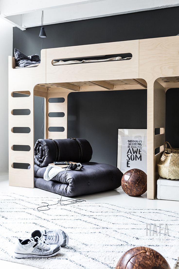 a loft bed with two bunk beds underneath it and other items on the floor next to it