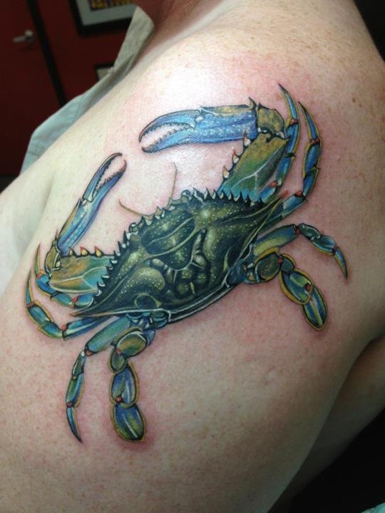 a man with a crab tattoo on his shoulder