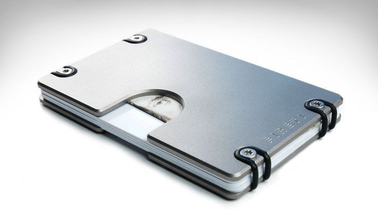 a metal wallet with a face on the front and back sides, is shown against a white background