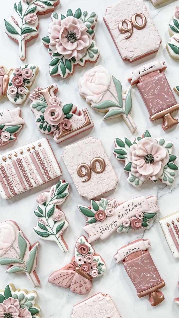 many decorated cookies are arranged on a table