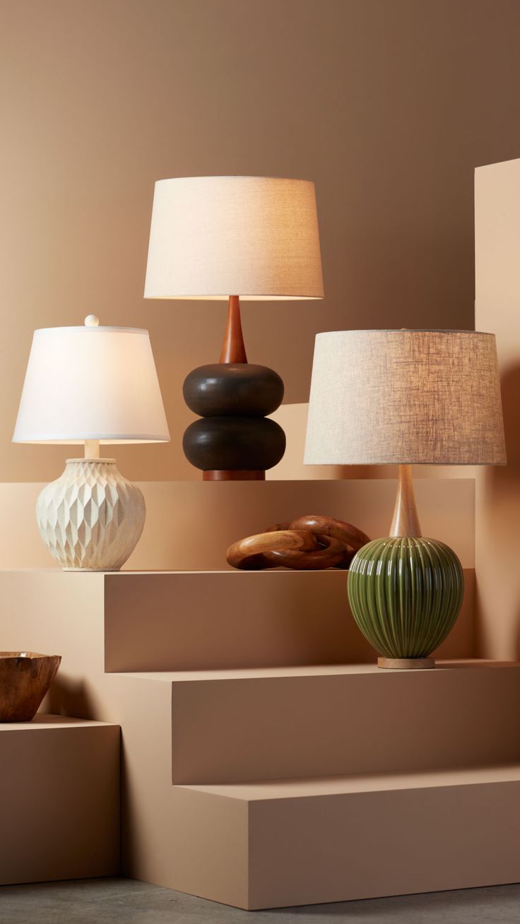 several different lamps are sitting on the shelf