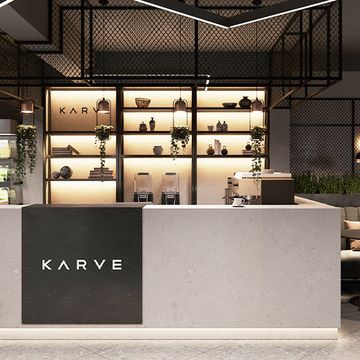 the interior of a shoe store with shelves and planters on the wall behind the counter