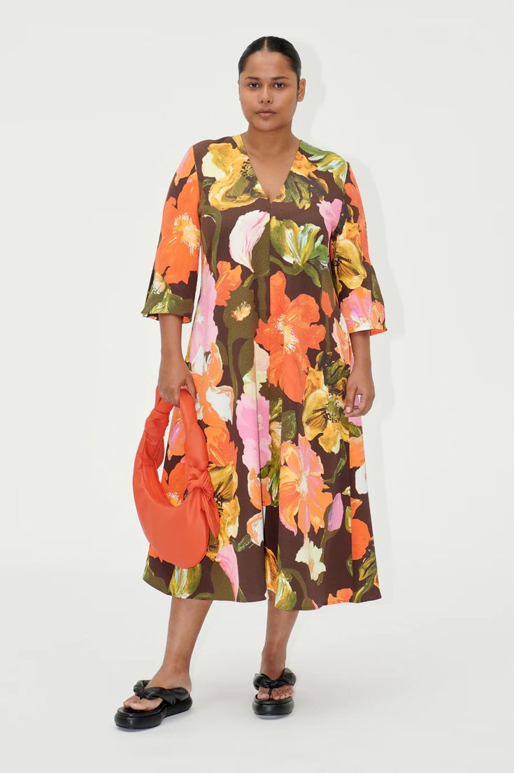 Step into a world of vibrant elegance with the Vic Dress by Stine Goya. This eye-catching piece features an oversized, mid-length silhouette, perfect for making a statement. Bold Dresses For Spring Vacation, Oversized V-neck Floral Print Dress, Oversized Orange Dresses For Spring, Oversized A-line Midi Dress For Spring, Multicolor Oversized V-neck Dress, Oversized Floral Print Dress For Daywear, Oversized Multicolor V-neck Dress, Designer Hair Accessories, Stine Goya