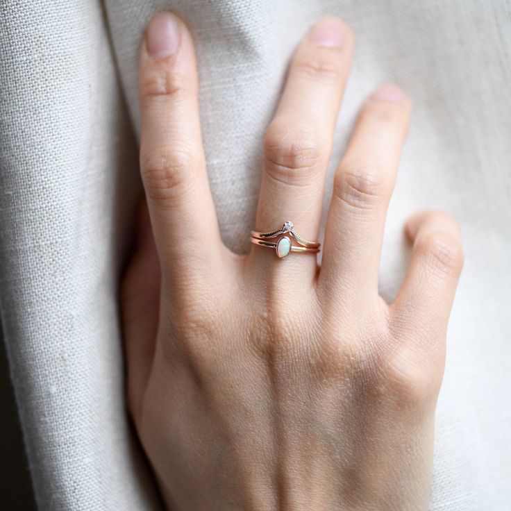 -Simple oval ring stacked with milgrain crown chevron. -14k Solid rose gold fully hallmarked. -Total diamond weight: 0.02ct-Diamond: 1.75mm-Clarity: SI1-Color: G+-Cut: Brilliant -1.4mm band width. -3x5mm Genuine Australian opal-1.75mm round diamond All of our jewelry will arrive in custom packaging ready for gift giving. LEAD TIME:Made to order will take 10-14 days. Oval Stackable Rings With Single Diamond, Minimalist Oval Diamond Stackable Rings, Delicate Stackable Oval Rings, Delicate Oval Stackable Rings, Timeless Oval Stackable Rings, Oval Stackable Wedding Rings With Single Diamond, Timeless Oval Diamond Stackable Ring, Timeless Oval Stackable Diamond Ring, 14k Gold Oval Diamond Stackable Ring