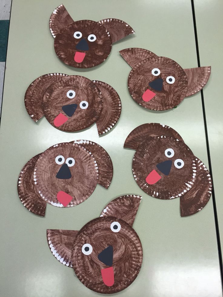 four paper plates with brown dog faces on them