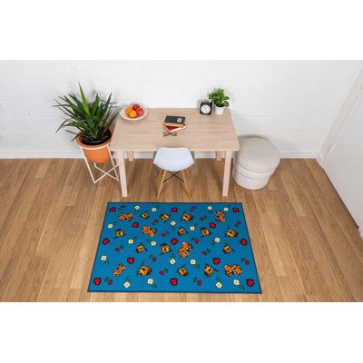 a room with a table, chair and potted plant on the floor in front of it