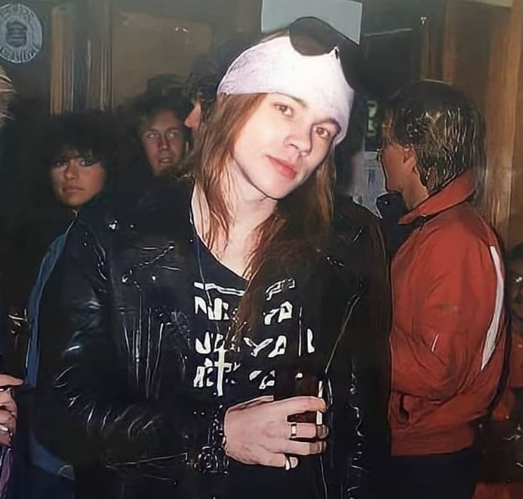 a woman wearing a white hat and leather jacket