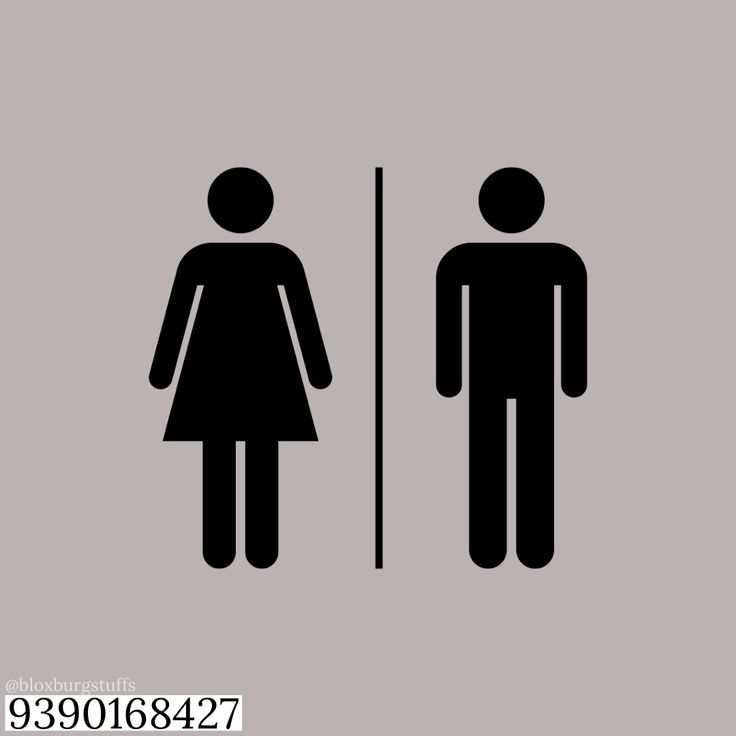 a man and woman standing next to each other in front of a bathroom door sign