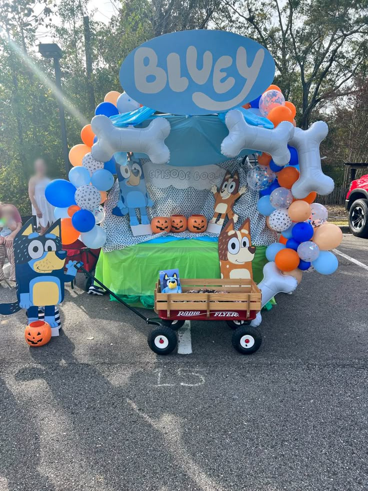 an outdoor display with balloons and decorations in the shape of cartoon characters, including bluey