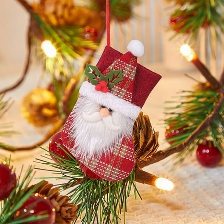 a christmas ornament hanging from a pine cone on top of a tree branch