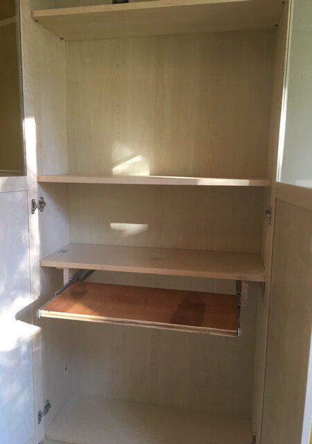 empty shelves in the corner of a room