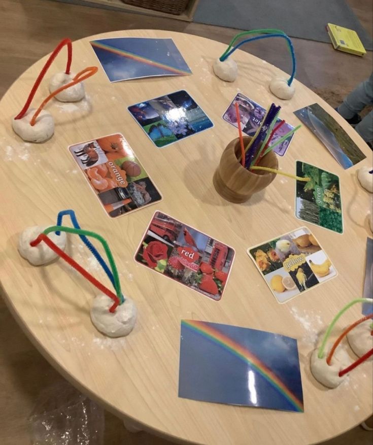 a wooden table topped with pictures and cards on top of it's sides,