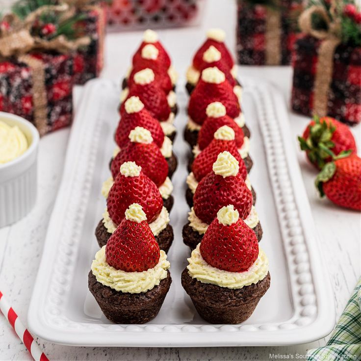 strawberries are arranged on top of chocolate covered cupcakes