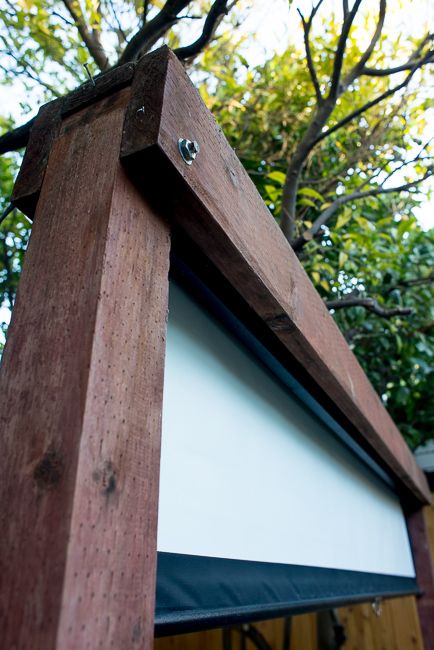 a wooden structure with a white screen on it