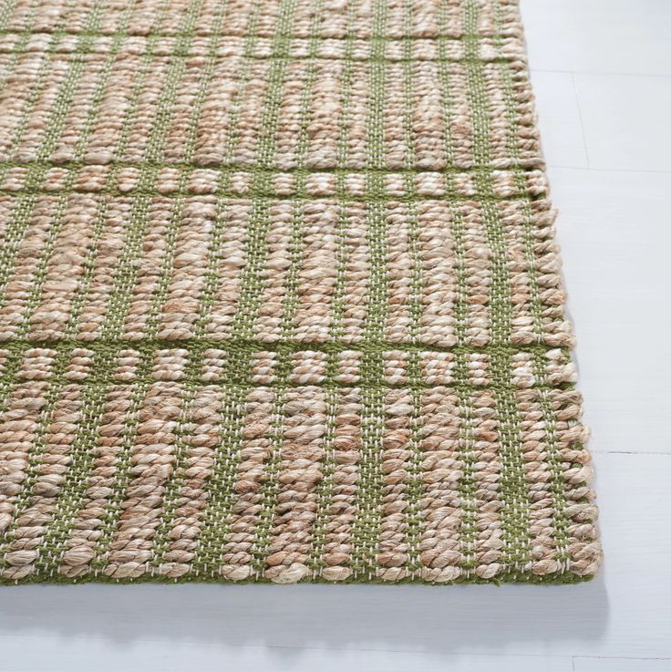 a green and beige area rug on the floor