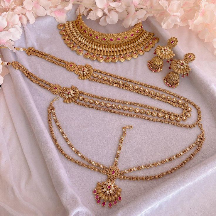 Luxury Matt Gold plate polished Kundan gem full bridal set with ruby gems. Bridal set includes, Necklace, Long mala, Earrings and mathapatti. This set is ready to ship as seen with gift box. Wedding And Navratri Stone Work Sets, Tilla Chandbali Bridal Set Gift, Chandbali Tilla Bridal Sets As Gift, Temple Jewelry Style Kundan Necklace For Marriage, Gold Temple Jewelry Bridal Accessories With Stone Work, Traditional Kundan Bridal Sets For Marriage, Temple Style Kundan Necklace For Marriage, Temple Jewelry Sets In 22k Gold For Wedding, 22k Gold Temple Jewelry Sets For Wedding