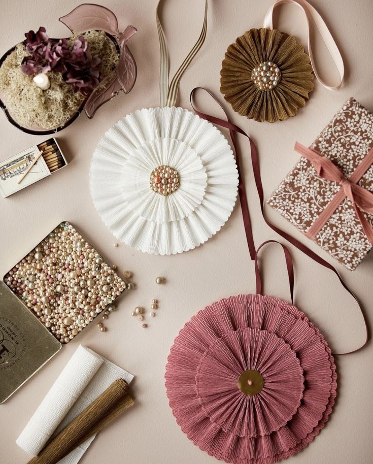 several different types of purses and accessories laid out on top of a pink surface