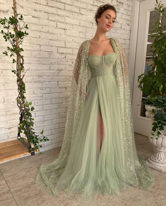 Aurora Cape Gown | Teuta Matoshi Vestidos Color Pastel, Sage Green Prom Dress, Green Wedding Dresses, Sparkly Prom Dress, Special Occasion Gowns, Cape Gown, Elegant Prom Dresses, Prom Dresses Modest, Prom Dress Inspiration