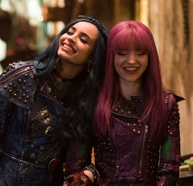 two women with red hair are standing next to each other and smiling at the camera