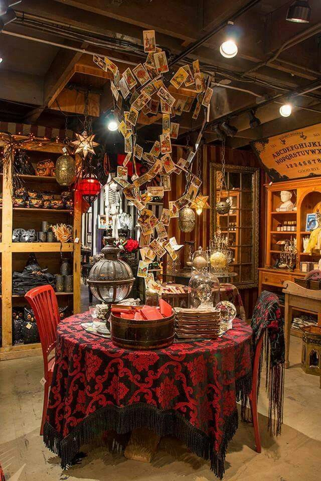 a table with many items on it in a room filled with books and other things