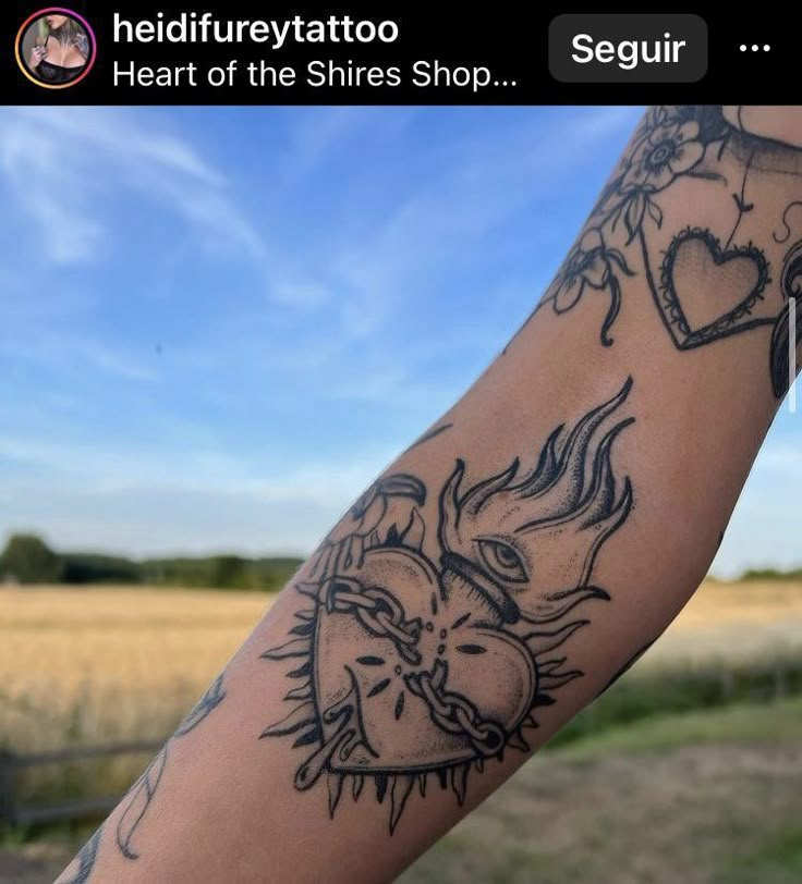 a person with a heart tattoo on their arm