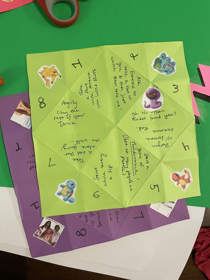 a green piece of paper with writing on it next to scissors and other crafting supplies