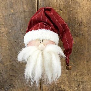 a red and white santa clause hat on top of a wooden pole