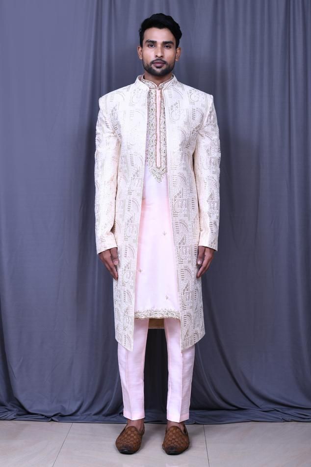 Light pink art silk front-open sherwani with floral, thread and sequins embroidery. Comes with pink banglori silk straight-fit pant and a kurta.
Components: 3
Pattern: Embroidered
Type Of Work: Floral, Thread, Sequins
Neckline: Mandarin collar
Sleeve Type: Full
Fabric: Banglori silk, Sherwani: Art silk
Color: Pink
Other Details: 
Closure: Sherwani and Kurta - Front buttons
Occasion: Wedding - Aza Fashions Long Traditional Wear With Dabka Work For Reception, Long Kurta With Dabka Work For Reception, Semi-stitched Naqshi Traditional Wear For Reception, Unstitched Traditional Wear With Naqshi For Reception, Pink Sherwani With Resham Embroidery In Traditional Drape, Semi-stitched Pink Sherwani With Intricate Embroidery, Pink Raw Silk Sherwani With Traditional Drape, Pink Sherwani With Dabka Work For Eid, Pink Sherwani With Zari Work For Reception