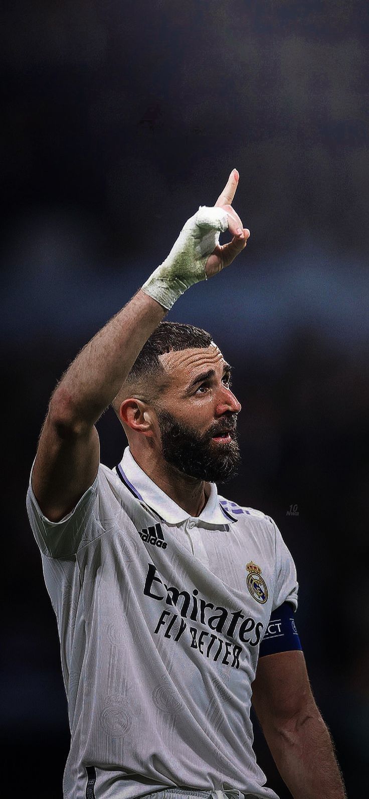 a soccer player with his hand up in the air