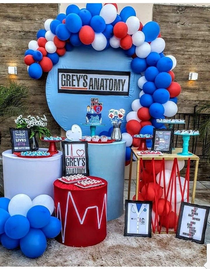 an assortment of balloons and decorations at a gray's anatomy themed birthday party in red, white, and blue