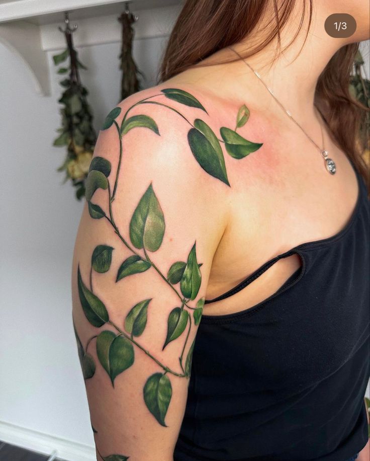 a woman with green leaves on her arm