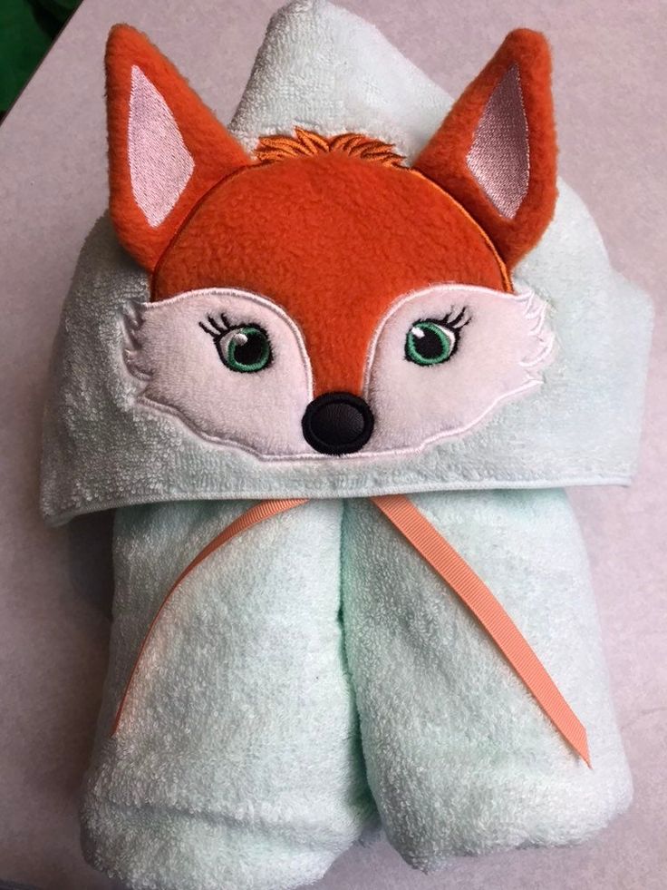 a towel with a red fox on it sitting on top of a white countertop