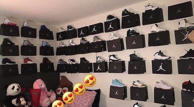 a room filled with lots of black and white wall hangings covered in air jordan shoes