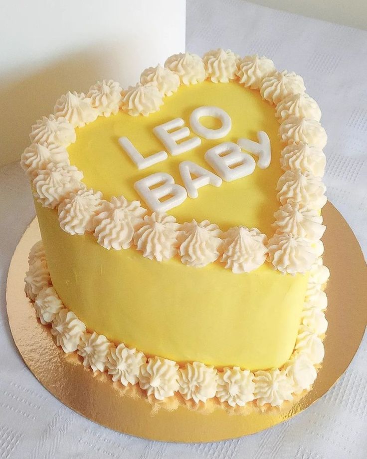 a heart shaped cake with the words leo baby written on it's frosting